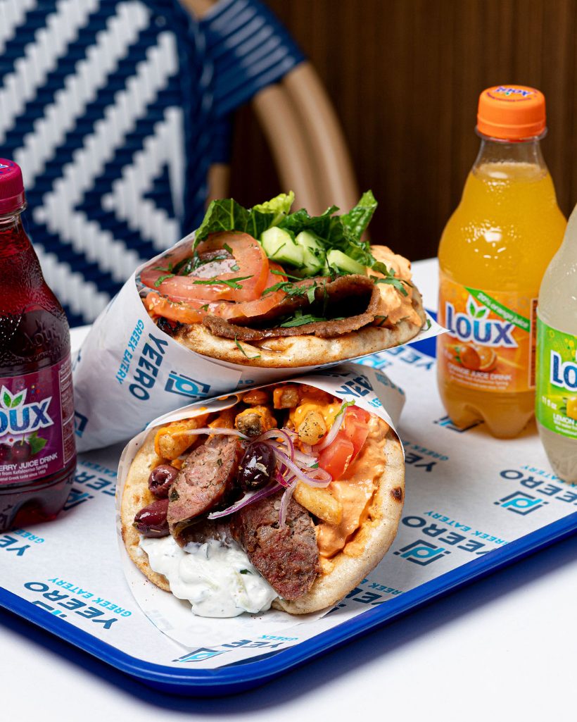 Two Gyro pitas with drinks ready for pickup